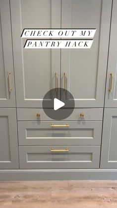 the kitchen cabinets are painted gray with gold handles and knobs, along with an arrow pointing to check out my pantry track