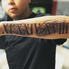 a man with a tattoo on his arm that says roman numerals and an eagle