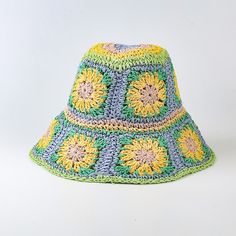 a multicolored crocheted sunflower hat on a white background