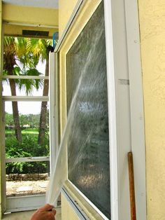 a person is spraying water on the window