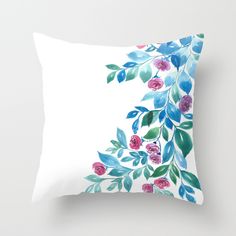 a white pillow with blue and pink flowers on it