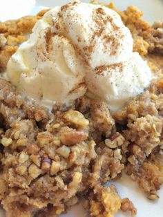 a close up of a plate of food with ice cream on top and nuts in the middle