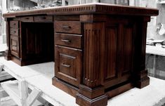 two wooden desks sitting on top of a table in a room filled with furniture