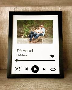 an mp3 player is sitting on a shelf next to a photo frame with the words, the heart rob & dixie