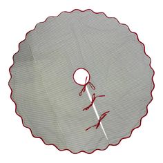 an image of a round object with red thread on the edge and white paper in the middle