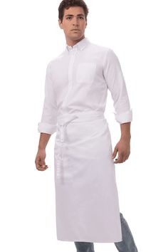 a man in a white chef's coat and jeans is posing for the camera