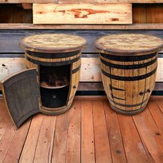 two wooden barrels sitting on top of a wooden floor