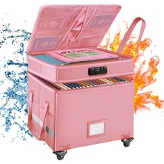 a pink cooler with an open lid on wheels in front of fire and water spewing around it