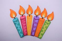 a group of colorful candles sitting on top of each other