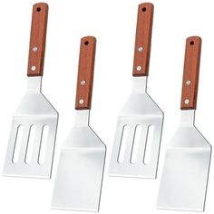 three white spatulas with wooden handles are shown in front of a white background