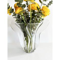 a vase filled with yellow flowers on top of a table