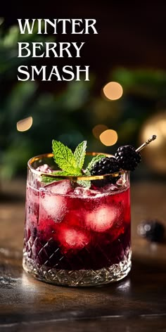 a drink in a glass with ice and berries on the rim