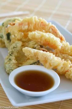 some fried food on a plate with dipping sauce