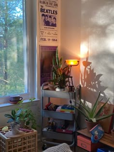 a living room with plants and books on the shelf in front of a large window