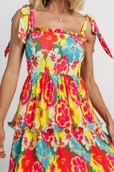 This dress will make you the standout at any event Vibrant multicolored floral pattern Medium-weight tight pleated chiffon Splice neckline with small ruffle Fully smocked bodice Self-tie straps Three tiered midi-length skirt with subtle flounce ruffle Fully lined Self: 100% Polyester, Lining: 100% Polyester Trina is 5'6, cup size 32D, size 2 and is wearing size S Pleated Chiffon, Three Tier, Midi Length Skirts, Aruba, Cup Size, Tiered Dress, Medium Weight, Midi Length, Floral Pattern