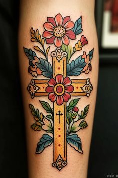 a cross with flowers on it and leaves around the cross is shown in this tattoo design