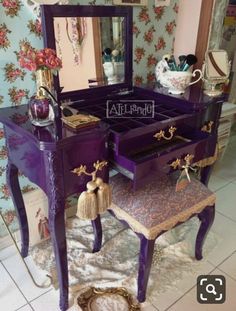 an ornate purple vanity with mirror and stool