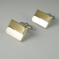 A unique pair of mid century fine sterling silver gold plated accent one of a kind cufflinks circa 1950.These classic 1950s cufflinks have gold plated accents and a unique design which catches the light from every angle.The front of the cufflinks is plated in gold and the backs and cuff link fittings are silver.The design is quite timeless.Together they weigh 14.33 grams.They are each clearly marked on the cuff link fittings 835 for fine European silver.Each of the classic design cufflink faces Modern Yellow Gold Formal Cufflinks, Modern Yellow Gold Cufflinks For Formal Wear, Luxury Rectangular Cufflinks For Anniversary, Modern Gold Cufflinks For Formal Wear, Modern Gold Cufflinks For Formal Occasions, Classic Hallmarked White Gold Cufflinks, Modernist Cuff Jewelry For Gift, Luxury Rectangular Cufflinks For Wedding, Timeless White Cufflinks As Gift