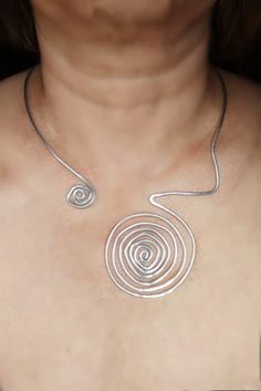 Choker necklace silver plated wire spiral jewelry Swirls necklace Asymmetric necklace Open silver necklace Collar choker Modern necklace Handmade necklace made of silver plated wire wire (2.5 mm, 10 gauge ). Silver plated wire is a metal that does not change its properties, does not tarnish ,and is not damaged over time. Nickel free and lead free. Silver plated wire is a soft metal, so the necklace is flexible and easily adjustable, but It's possible to adjust the necklace just a little bit, but not too much not to lose the form. The standard size is appropriate for my neck line so you can have the orientation according to the photo. Silver Spiral Metal Necklaces, Silver Wire-wrapped Necklace, Unique Silver Wire Necklaces, Adjustable Spiral Silver Necklace, Silver Wire Wrapped Jewelry With Swirl Design, Silver Spiral Metal Necklace, Silver Swirl Wire Wrapped Jewelry, Silver Wire Wrapped Swirl Jewelry, Silver Wire Wrapped Necklace