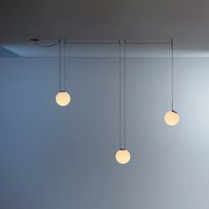 three lights hanging from the ceiling in a room