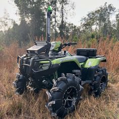 a green four - wheeler parked in the middle of a field