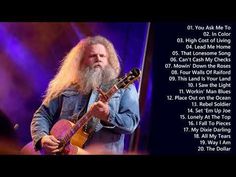 an image of a man with long hair and beard holding a guitar in his hand