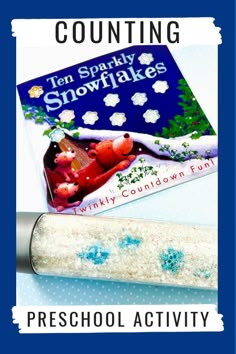 a book and pencil sitting on top of a table with the title, counting snowflakes