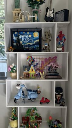 a shelf filled with toy figurines on top of white shelves next to a window