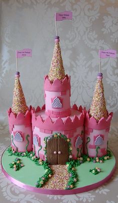 a cake that is shaped like a pink castle