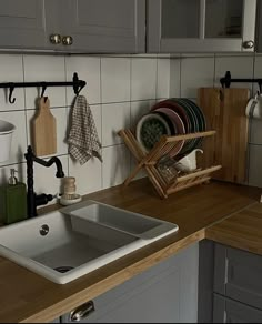 a kitchen sink sitting on top of a wooden counter