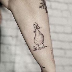 a duck tattoo on the left arm