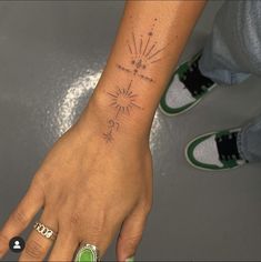 a person's hand with a small tattoo on it