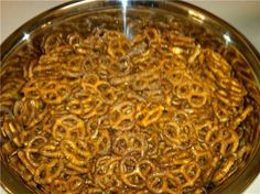 a large metal bowl filled with lots of pretzels