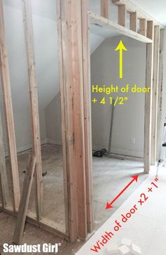 an unfinished room with measurements for the height of the door