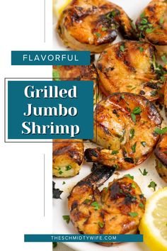 grilled jumbo shrimp on a plate with lemon wedges