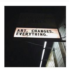 a black and white photo of a street sign that says art changes everything on it