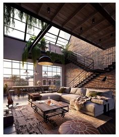 a living room filled with lots of furniture next to a staircase leading up to a loft