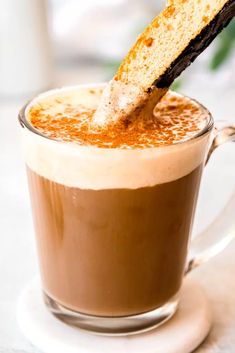 a piece of cake sticking out of a cup of coffee