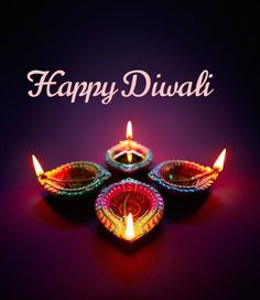 happy diwali greeting card with three lit candles in the shape of a heart