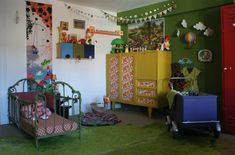 a child's room with green walls and furniture