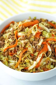 a white bowl filled with cabbage and carrots