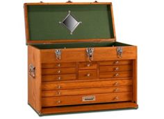 an old fashioned wooden chest with many drawers and locks on the front, open to show its contents