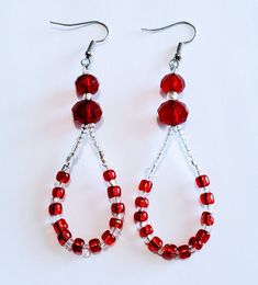 pair of red beaded earrings on white background