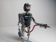 a robot holding a wrench and some wires