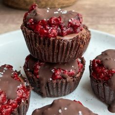 chocolate cupcakes with raspberry filling on a white plate