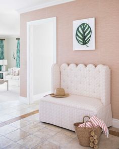 a white bench sitting in the middle of a living room next to a door and window