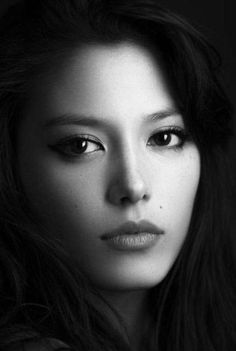 a black and white photo of a woman with long hair