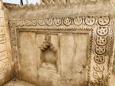 an intricately carved stone wall with carvings on it