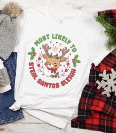 This Christmas group tshirt listing gives you the option of choosing your favorite christmas sayings for you and your family and friends.  Please select your design and size in teh options window.  Please dont hesitate to message us with any concerns or questions.  This classic unisex jersey short sleeve tee fits like a well-loved favorite. Soft cotton and quality print make users fall in love with it over and over again. These t-shirts have-ribbed knit collars to bolster shaping. The shoulders Group Christmas Shirts, Rudolph Shirt, Christmas Sayings, Rudolph Reindeer, Reindeer Shirt, Rudolph The Red Nosed Reindeer, Cozy Day, Group Shirts, Rudolph The Red