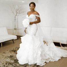 a woman in a white wedding dress posing for the camera